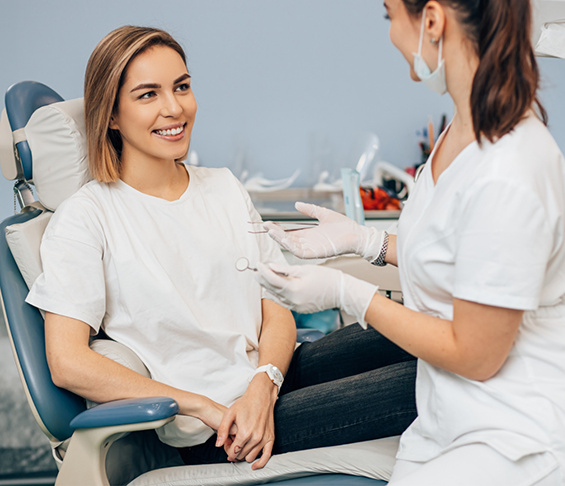 Woman in the dental chair listening to her dentist