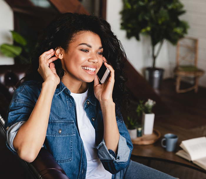 Young woman talking on the phone with endodontic office in Bloomfield