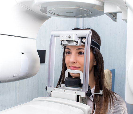 Dental patient getting a C T cone beam scan of her mouth and jaws
