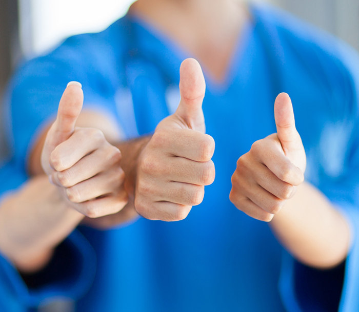 Three Bloomfield endodontic team members giivng thumbs up