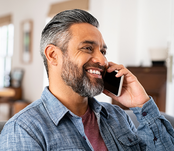 man talking on the phone to request an endodontic appointment in Bloomfield