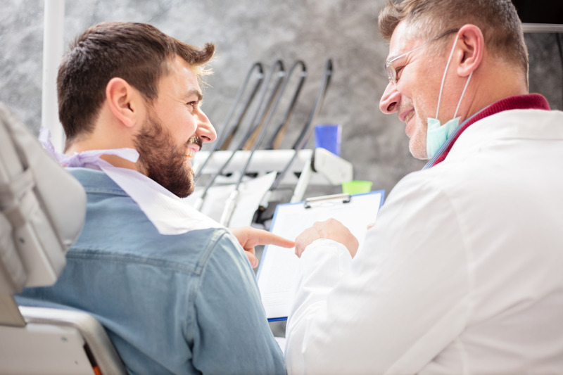 Patient smiling with dentist after root canals
